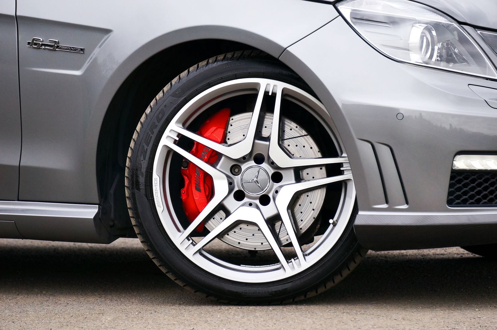A polished alloy wheel and brake calliper on a clean car